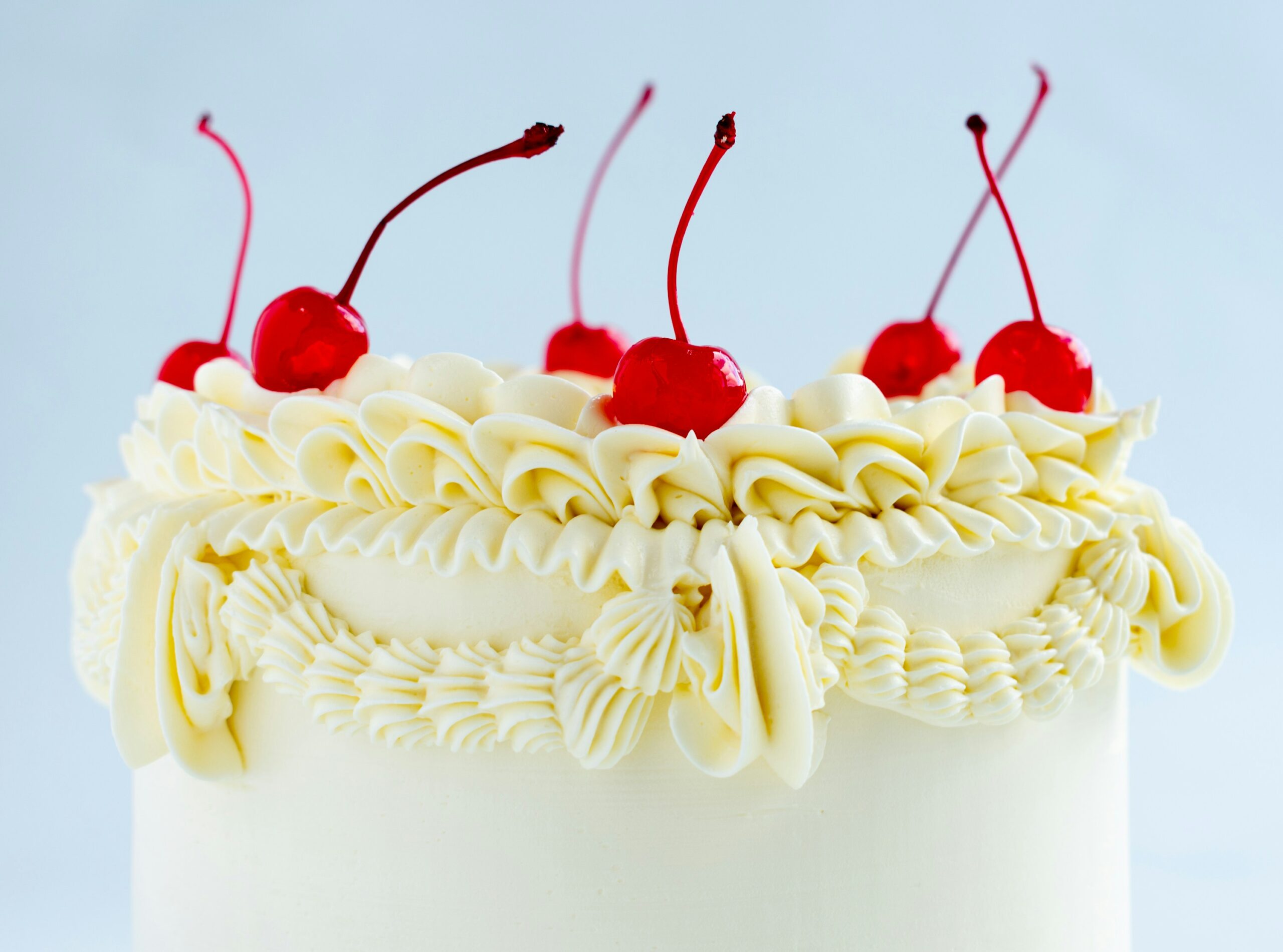 Buttercream cake with vintage piping, Lambeth method cake design, stemmed maraschino cherries on top